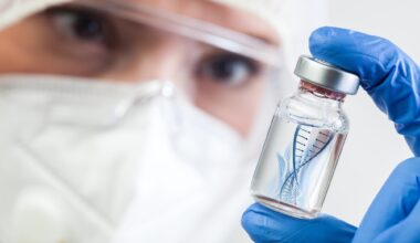 Microbiologist Biotechnician Holding mRNA Vaccine Vial