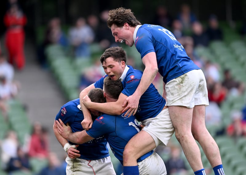 Conor Dean of St Mary's College (left) celebrates with teammates Mick O'Gara, Robert Gilsenan and Myles Carey after scoring his side's fifth try in Sunday's All-Ireland League Division 1A final against Clontarf at the Aviva Stadium. Photograph: Daire Brennan/Sportsfile