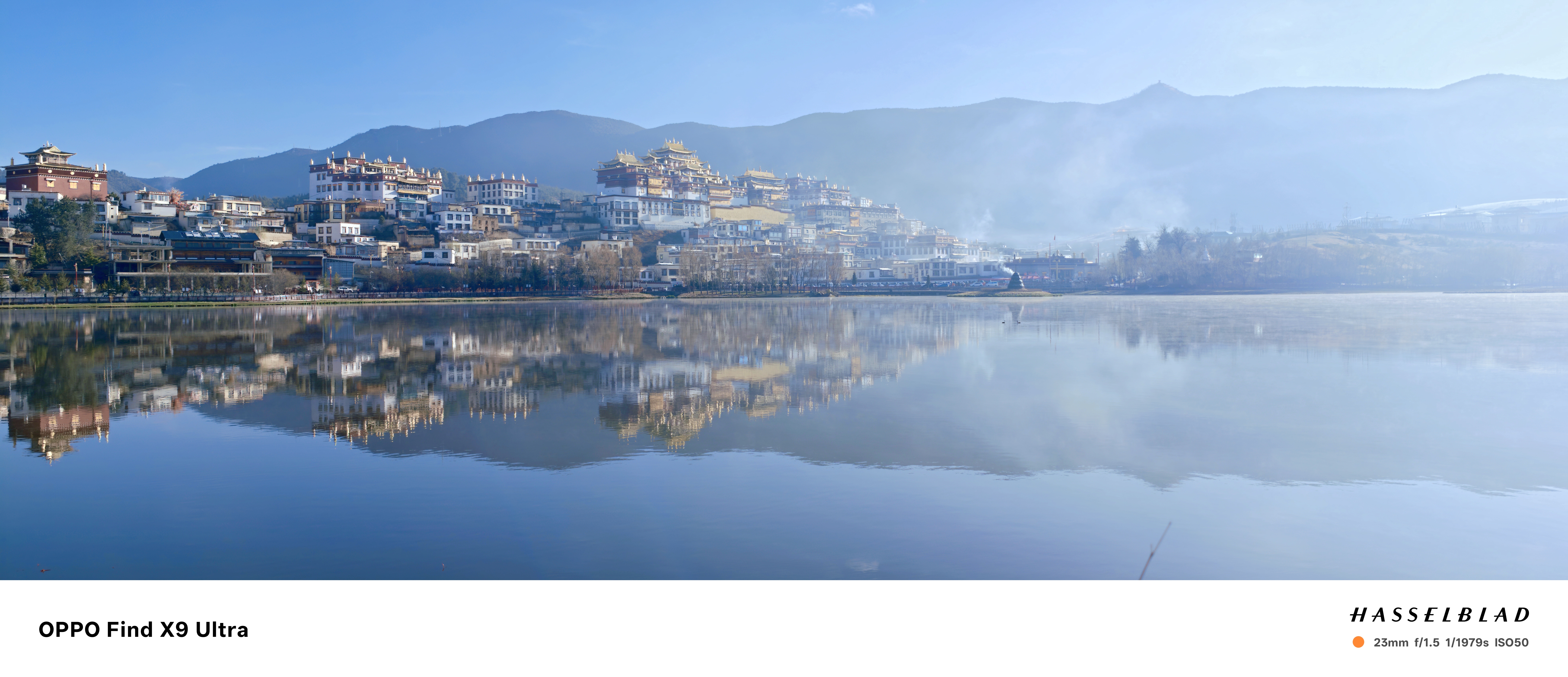 A buddhist monastery and town in the Yunnan province of China, reflected in a lake, at first light