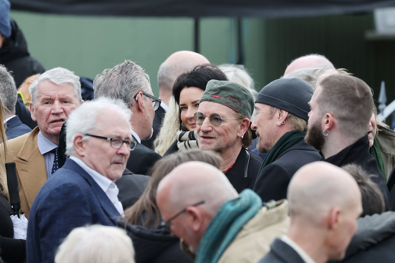 Moya Brennan's husband, Tim Jarvis, speaking with Bono and The Edge from U2 at the funeral. Photograph: Alan Betson