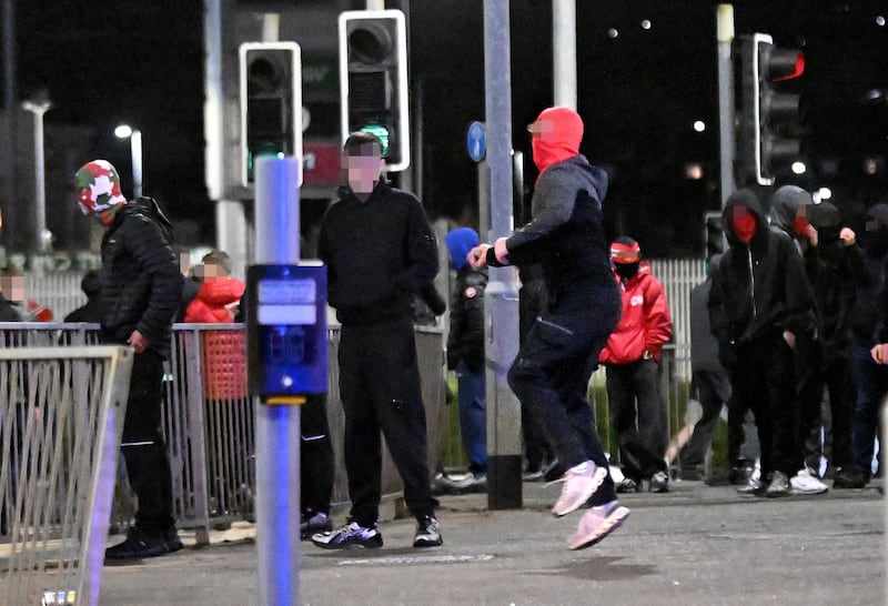 Cliftonville fan stones police lines at Broadway near Windsor Park after his team's defeat on penalties to Dungannon in the Irish Cup semi-final tonight.