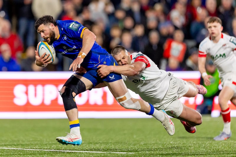 Leinster’s Robbie Henshaw runs in a try despite the attentions of Ulster’s Stuart McCloskey. Photograph: Morgan Treacy/Inpho