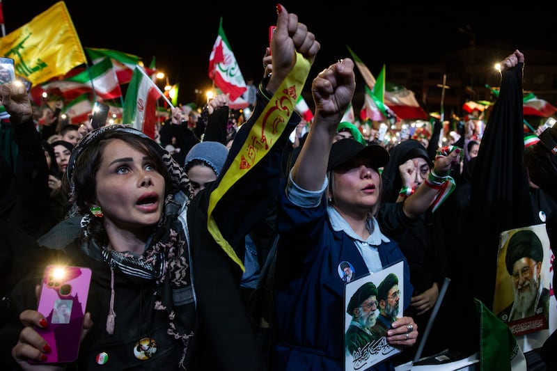 Women chant at a pro-government demonstration in Enghelab Square in Tehran, Iran, on Wednesday. Photograph by Arash Khamooshi/The New York Times
                      