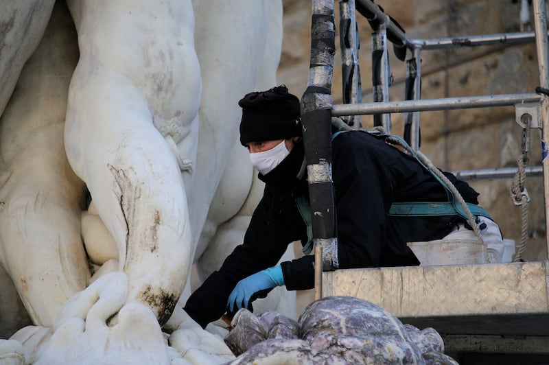 Cleaning and repair work taking place on the Neptune fountain in 2021. Photograph:  Paolo Lo Debole/Getty Images