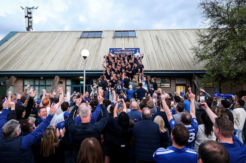 The St Mary’s College team and supporters celebrate with the trophy at the club after the game. Photograph: Ben Brady/Inpho