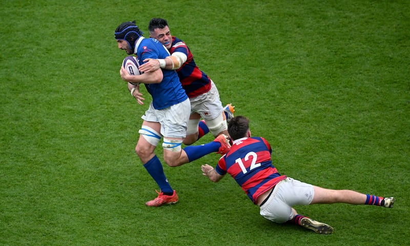 Greg Jones of St Mary's College is tackled by Jordan Coghlan (left) and Daniel Hawkshaw during Sunday's All-Ireland League Division 1A final at the Aviva Stadium. Photograph: Daire Brennan/Sportsfile