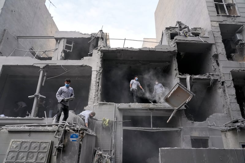 Volunteers clean debris from a residential building damaged when a nearby police station was hit Friday in a US-Israeli strike in Tehran. Photograph: Vahid Salemi/AP