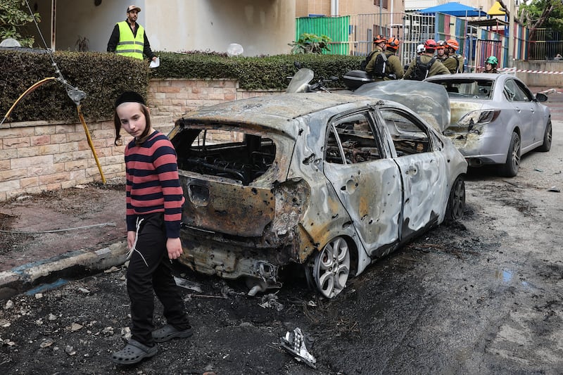 A child looks at the damage as first responders work at a site hit during an Iranian strike over Petah Tikva on Tuesday. Photograph: Jack Guez/ AFP via Getty Images