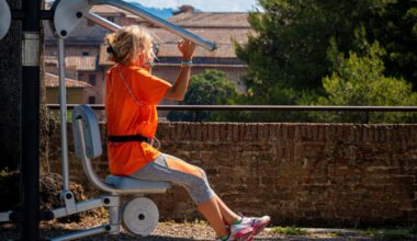 A woman uses outdoor gym equipment