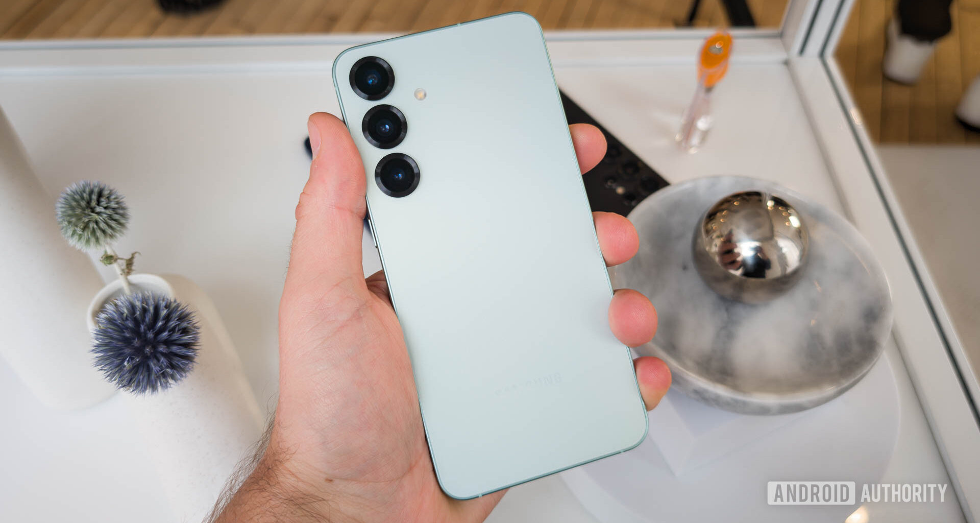 Samsung Galaxy S25 Plus in hand in Mint colorway