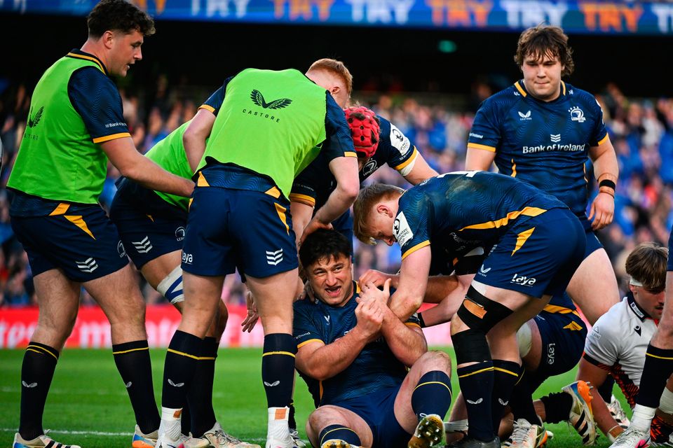 Thomas Clarkson of Leinster, centre, is congratulated by teammates after scoring his side's sixth try