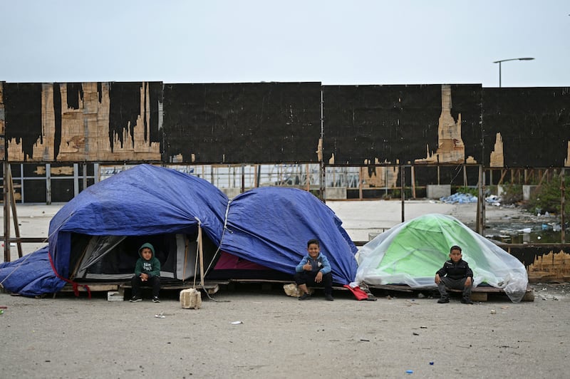 Displaced young children sit outside their tents at an unofficial camp for displaced people on Beirut's waterfront area on April 2th. Photo by Joseph EID / AFP via Getty Images
