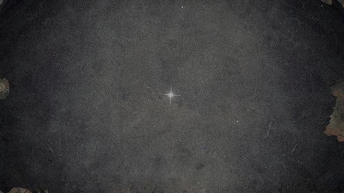 A star is pictured in a grey sky in an old photograph.
