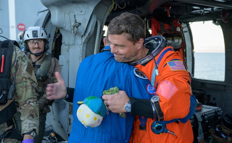 Nasa astronaut Reid Wiseman, Artemis II commander, gives flight surgeon Richard Scheuring a hug on the flight deck. Photograph: NASA/Bill Ingalls