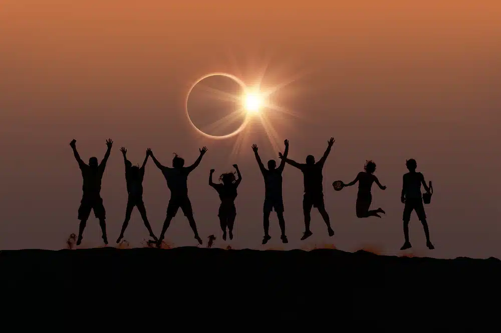 Silhouette,of,friends,jumping,at,solar,eclipse,"elements,of,this