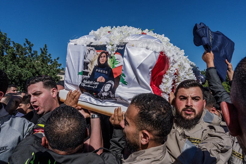 Mourners carry the coffin of Amal Khalil, a journalist who was killed by an Israeli strike, during her funeral procession in Baisariyeh, Lebanon, on Thursday. Photograph by Daniel Berehulak/The New York Times
                      