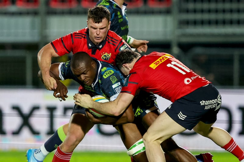 Benetton's Alessandro Izekor is tackled by Munster's Tom Farrell and Andrew Smith. Photograph: Roberto Bregani/Inpho