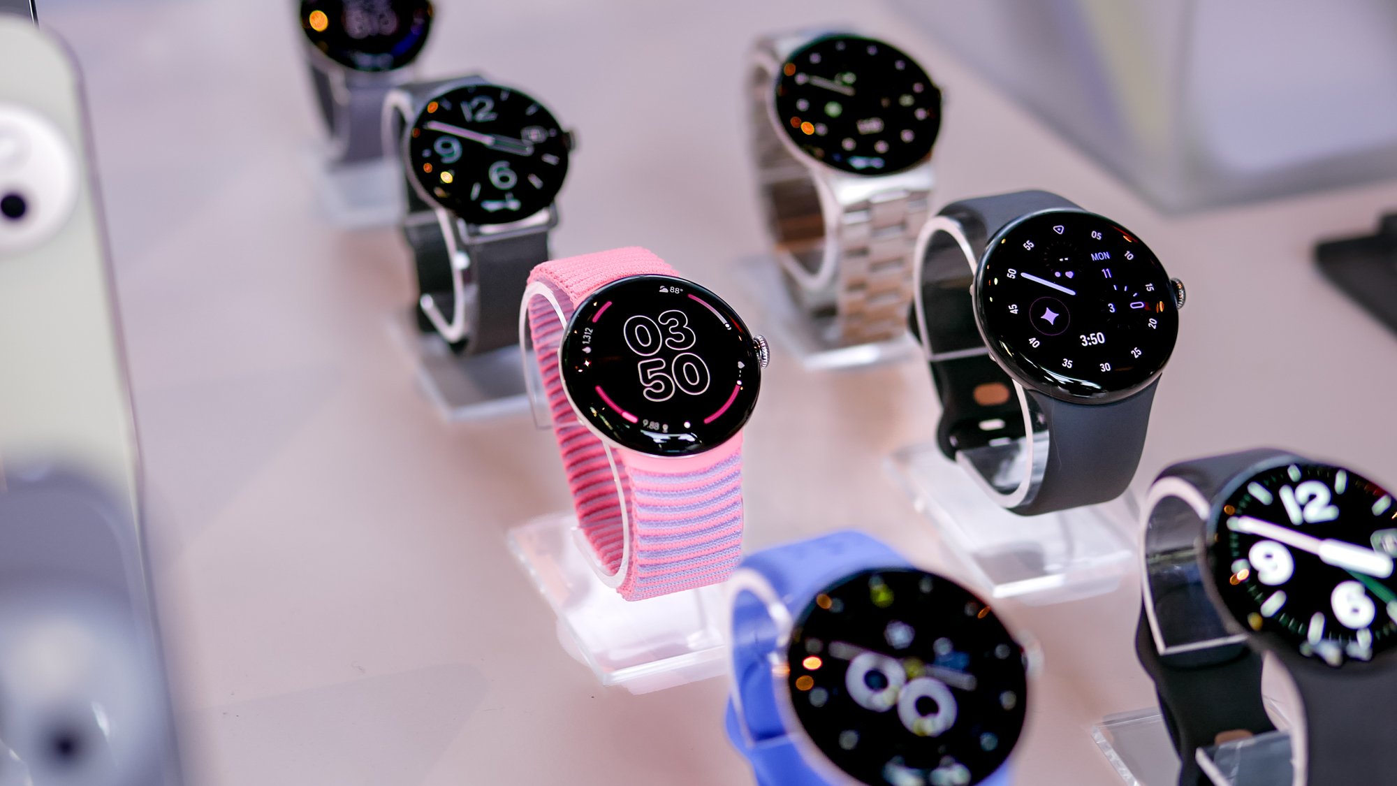 Close-up of a large selection Google Pixel Watch 4 models in different sizes and with different straps