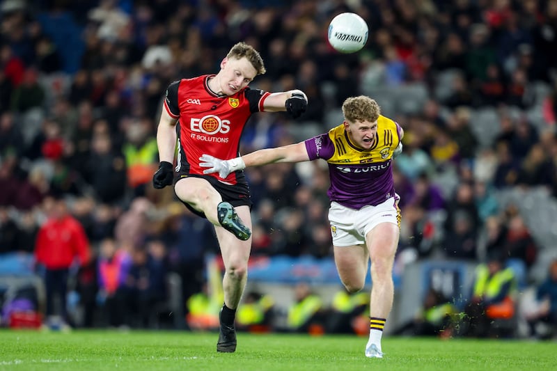Down's Odhran Murdock scores a point despite a challenge from Michael Kinsella of Wexford in the Division 3 final last month. Photograph: Nick Elliott/Inpho