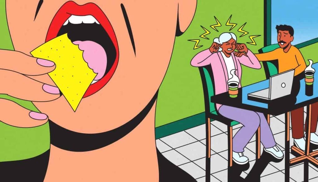 Close-up of a person eating a snack with a large mouth and hand holding a cracker.