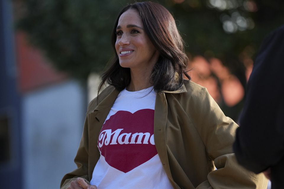 Meghan Markle on her Australian tour. Like her T-shirt and runners? Well, now you know where to buy. Photo: Getty