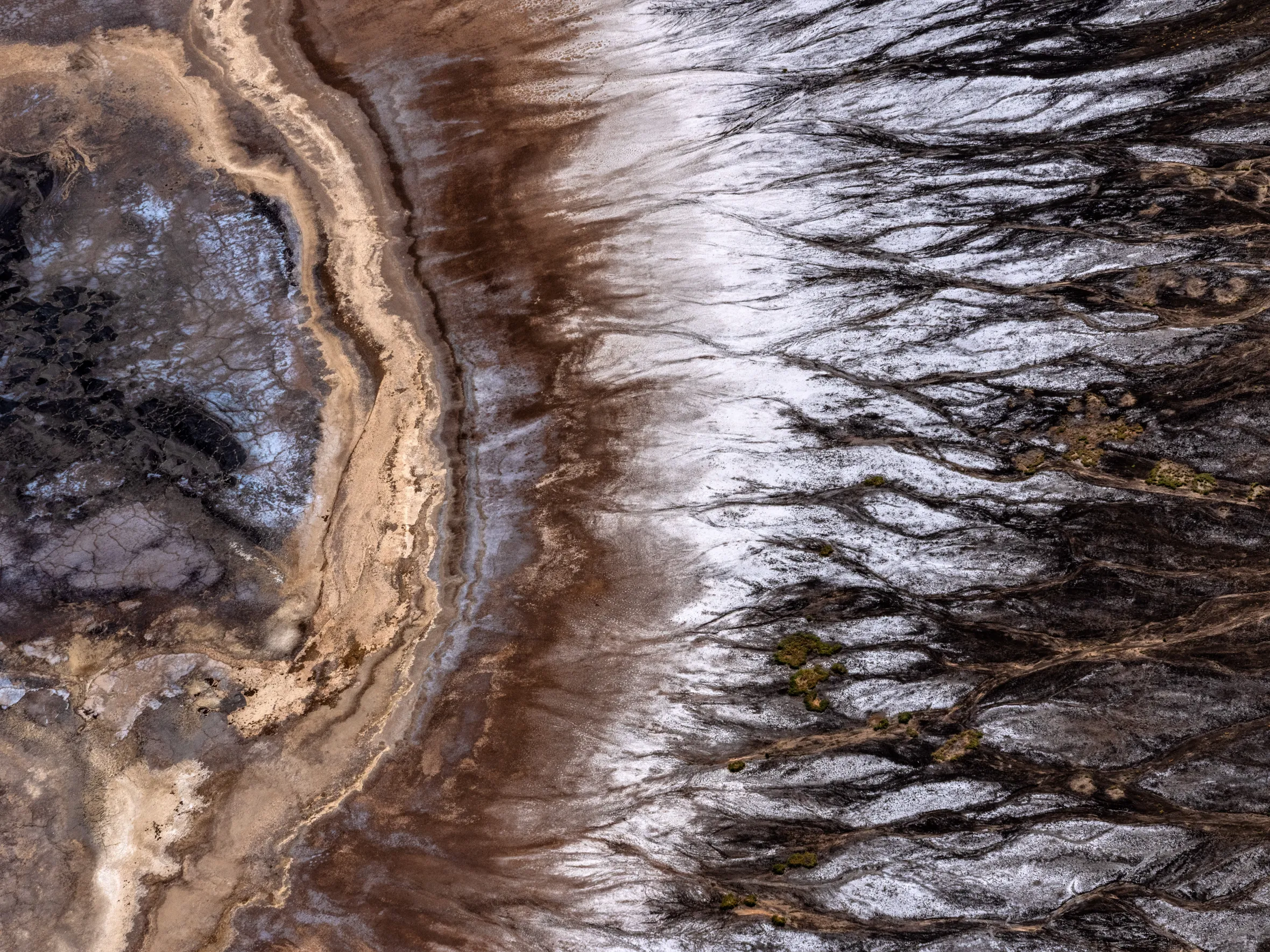Aerial view of intricate patterns of ash and mineral color where lava once flowed from the volcanoes of the Great Rift Valley.