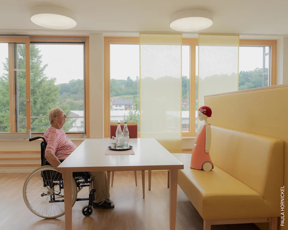 Waltraud talks with Emma, a social robot that recognizes faces and remembers past conversations. Though skeptical at first, Waltraud says she felt connected to Emma over time.