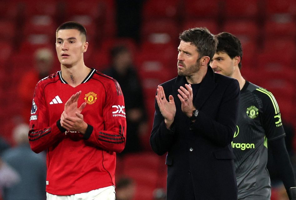 Manchester United manager Michael Carrick and Benjamin Sesko applaud fans after the match