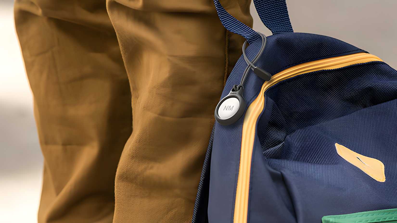 AirTag in carrying case on a backpack.