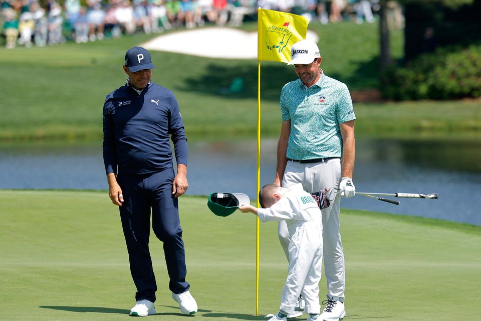 Golf - The Masters - Augusta National Golf Club, Augusta, Georgia, U.S. - April 8, 2026
Keegan Bradley of the U.S. with his son and Gary Woodland of the U.S. on the 6th hole during the par 3 contest REUTERS/Mike Blake