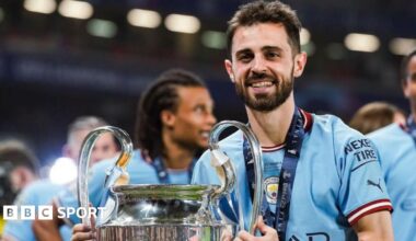 Bernardo Silva holding the Champions League trophy in 2023