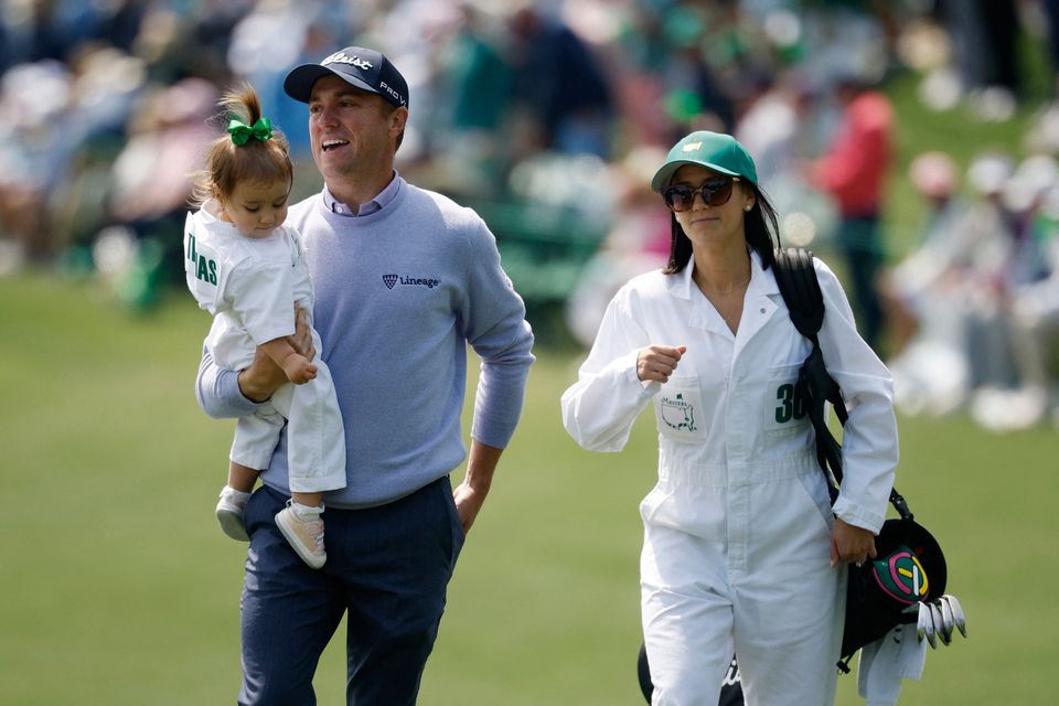 Golf - The Masters - Augusta National Golf Club, Augusta, Georgia, U.S. - April 8, 2026
Justin Thomas of the U.S. with his wife Jillian Wisniewski and daughter Molly Thomas on the 2nd hole during the par 3 contest REUTERS/Brian Snyder
