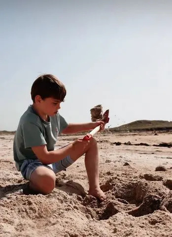 Prince Louis digging sand on the beach.Credit: Prince and Princess of Wales/Instagram