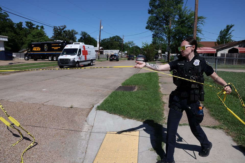 A Shreveport police officer works at the scene after children, with ages ranging from 1 to 14, were killed in a mass shooting incident described as domestic violence, in Shreveport, Louisiana, U.S. April 19, 2026.  REUTERS/Kevin Bartram