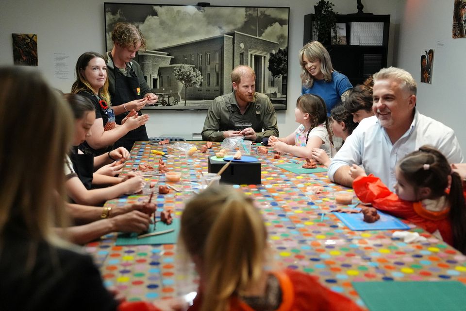 Britain's Prince Harry and Meghan, the Duke and Duchess of Sussex, take part in a model-making activity with veterans and their families at the Australian National Veterans Arts Museum (ANVAM) in Southbank, Melbourne, Australia, April 14, 2026. Jonathan Brady/Pool via REUTERS
