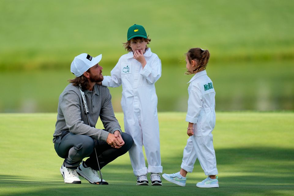 Tommy Fleetwood, left, talks with his son, Franklin, center, and Rory McIlroy's daughter, Poppy, during par-3 contest ahead of the Masters golf tournament at the Augusta National Golf Club, Wednesday, April 8, 2026, in Augusta, Ga. (AP Photo/Eric Gay)