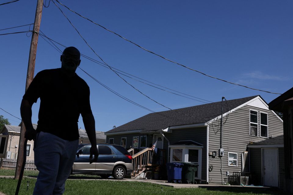 A man walks past the scene after children, with ages ranging from 1 to 14, were killed in a mass shooting incident described as domestic violence, in Shreveport, Louisiana, U.S. April 19, 2026.  REUTERS/Kevin Bartram