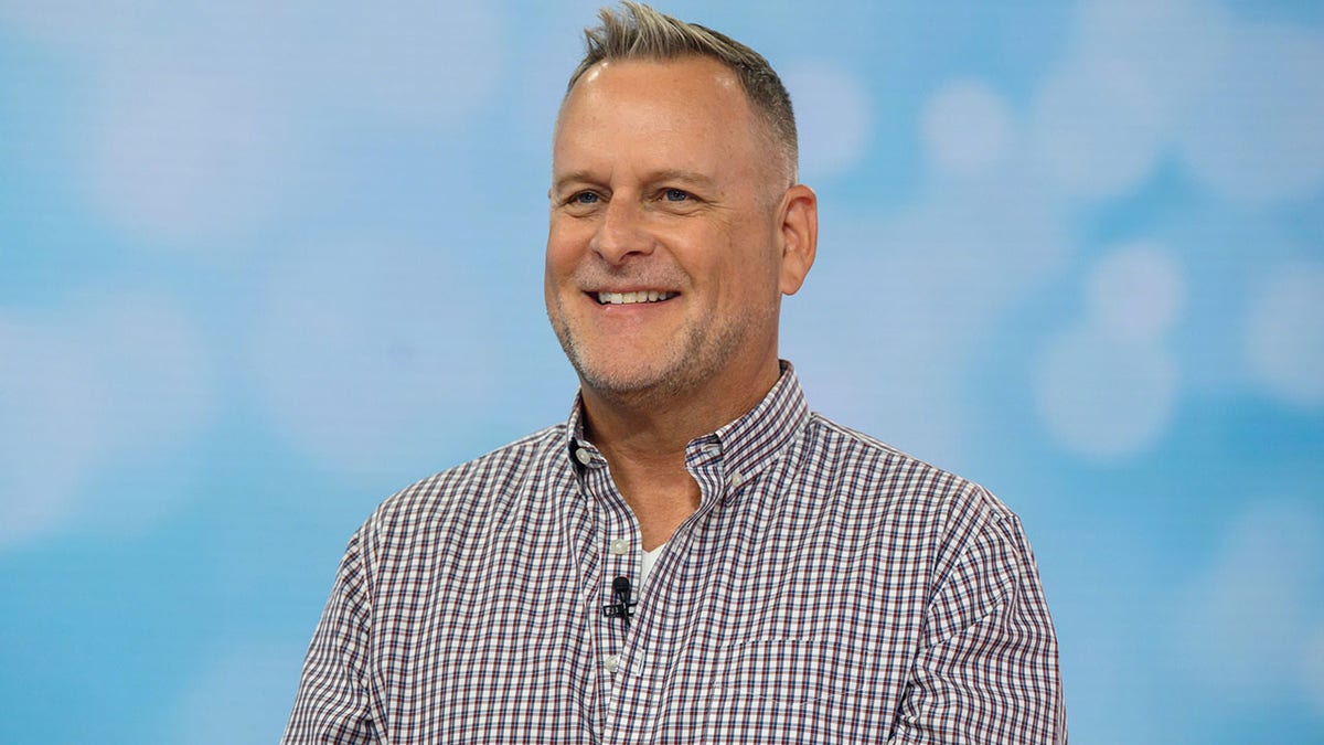 Actor and comedian Dave Coulier smiling on set