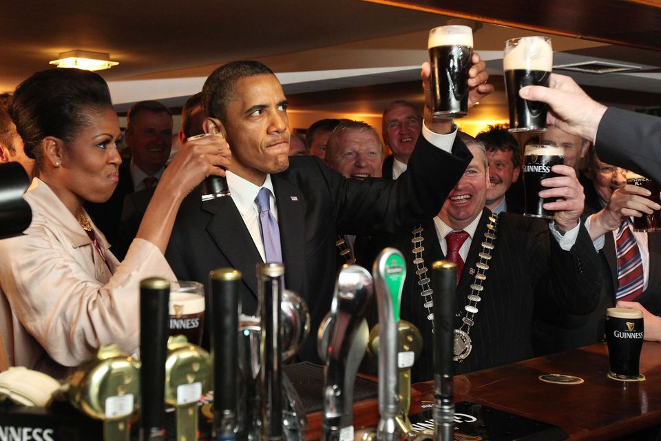 Barack Obama enjoys a glass of Guinness alongside his wife Michelle Obama in his ancestral home of Moneygall in 2011. Photo: Getty