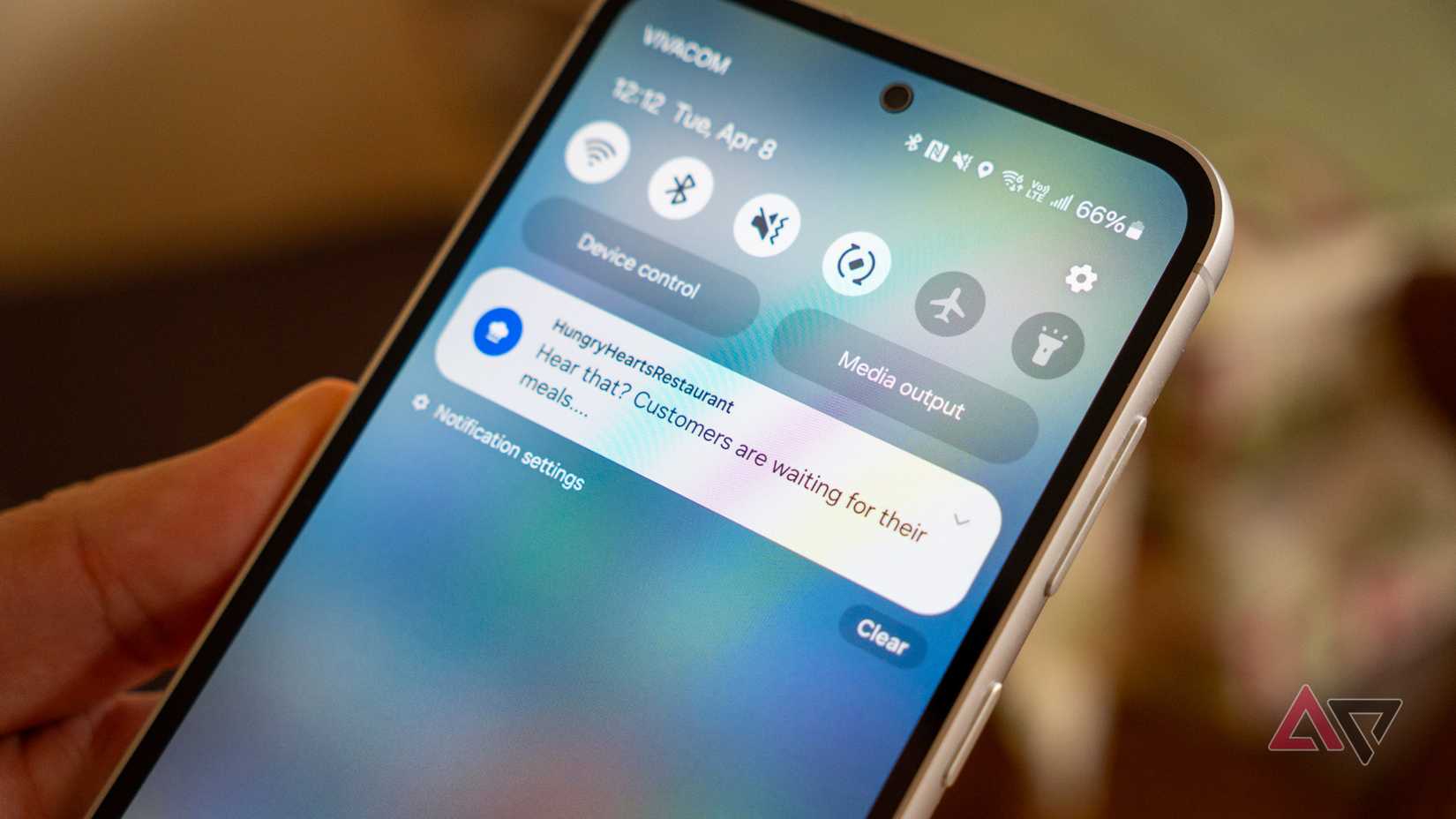 a phone in hand displaying a notification from a mobile game