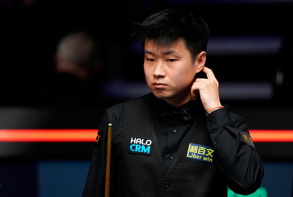 Zhao Xintong reacts after playing a shot during his quarter-final defeat