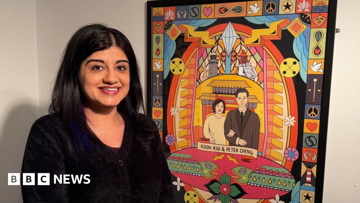 Sofia Barton, a middle-aged woman of South Asian heritage, standing next to a framed piece of digital artwork depicting Koon Kiu Cheng and her husband Peter Cheng, the founders of Newcastle's Chinatown. The design itself is bright and colourful, surrounded by symbols and patterns.
