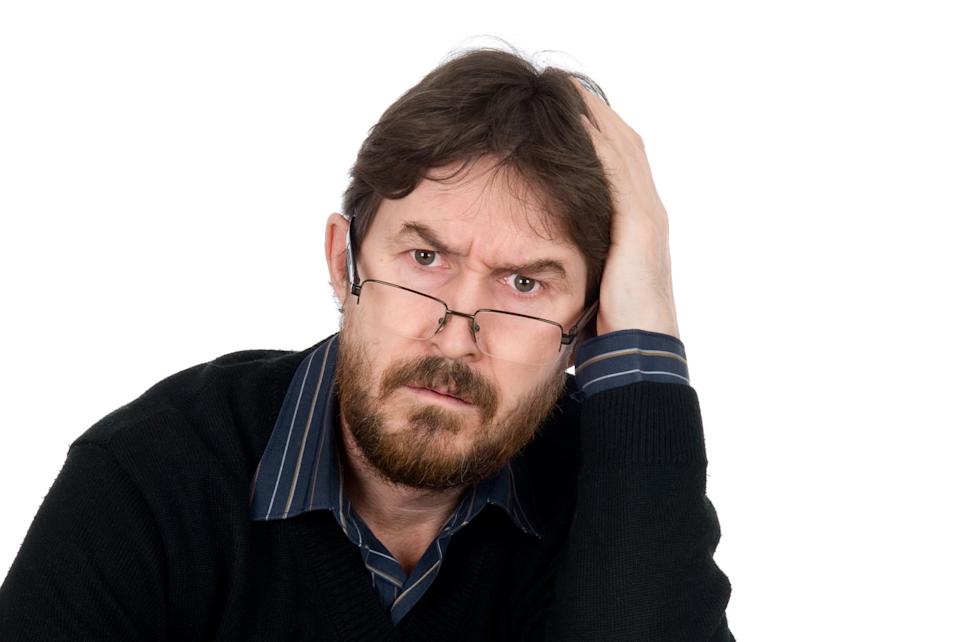 Person with their hand on their head, looking concerned.