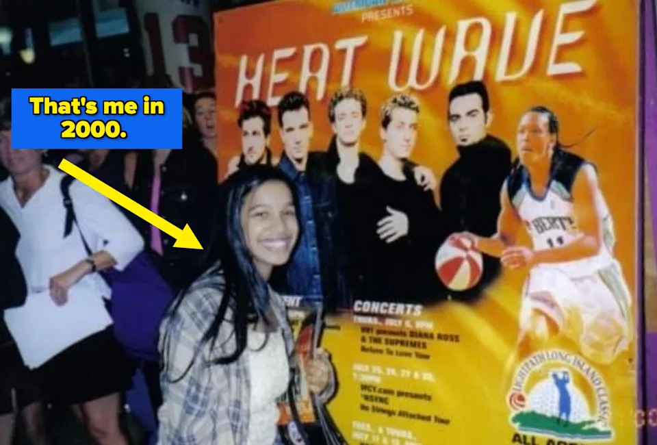 Person smiling in front of a "Heat Wave" concert poster featuring a basketball player and a band