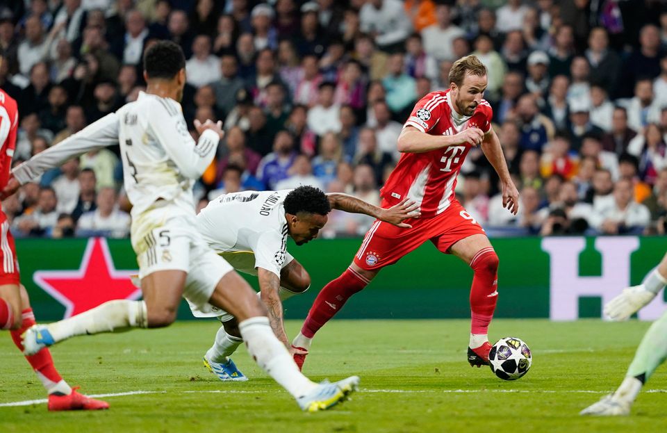 Bayern Munich's Harry Kane gets past Real Madrid's Eder Militao.