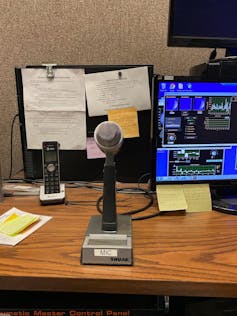 A microphone on a stand sitting on a desk.