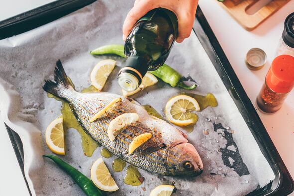 Fish stuffed with herbs and lemon slices. Fish stuffed with herbs and lemon slices.