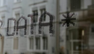 a close up of a window with a building in the background