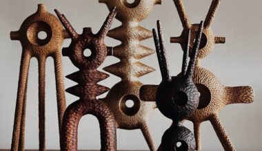 a collection of small, abstract, spindly wooden sculptures