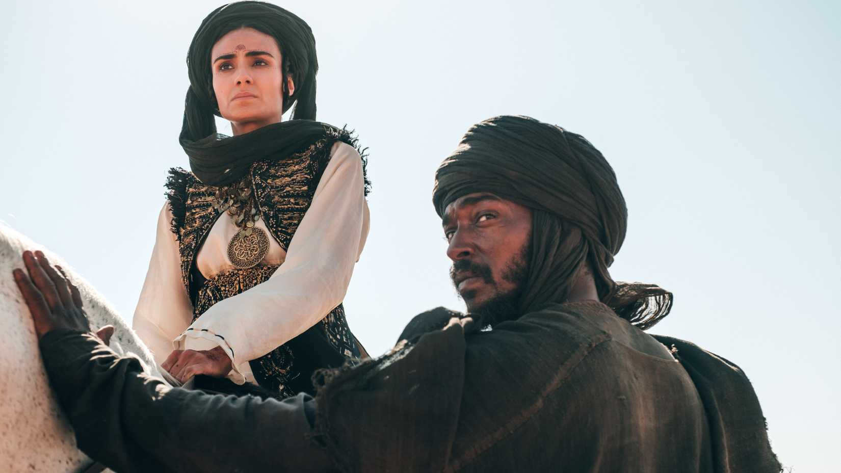 Hind on a horse with the bandit touching it and looking over his shoulder in Desert Warrior